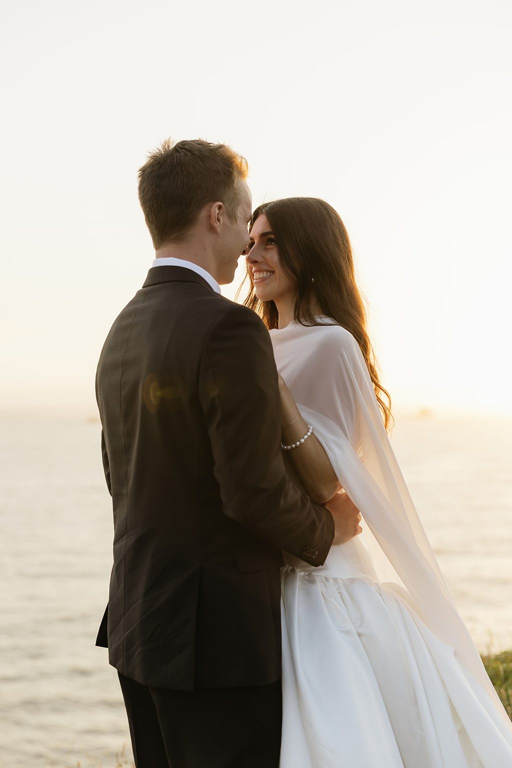 Couple eloping on the Oregon coast at sunset.